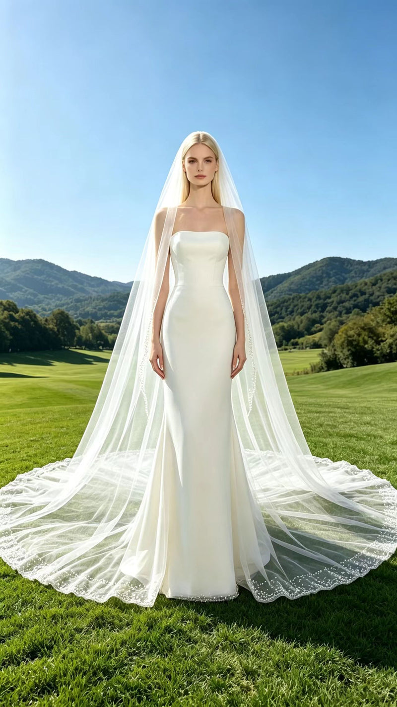 Front view of bride wearing shimmering beaded edge circular cathedral bridal veil on mountain meadow - Aurea Bridal